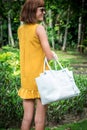 Portrait of a Beautiful fashionable caucasian brunette woman with sunglasses and luxury snakeskin python handbag posing Royalty Free Stock Photo