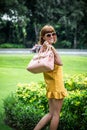 Portrait of a Beautiful fashionable caucasian brunette woman with sunglasses and luxury snakeskin python handbag posing Royalty Free Stock Photo