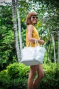 Portrait of a Beautiful fashionable caucasian brunette woman with sunglasses and luxury snakeskin python handbag posing Royalty Free Stock Photo