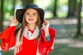 Portrait of a beautiful fashionable girl outdoor on sunny spring day, breating fresh air in park.