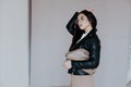 Portrait of a beautiful fashionable oriental brunette woman in a black leather jacket Royalty Free Stock Photo