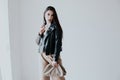 Portrait of a beautiful fashionable oriental brunette woman in a black leather jacket Royalty Free Stock Photo