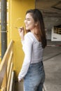Portrait of Beautiful fashionista woman in white shirt and blue jeans