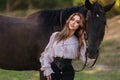 Portrait of a beautiful female cowgirl with shotgun from wild west riding a horse in the outback Royalty Free Stock Photo