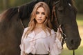 Portrait of a beautiful female cowgirl with shotgun from wild west riding a horse in the outback Royalty Free Stock Photo