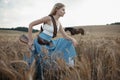 Portrait of a beautiful female cowgirl with shotgun from wild west riding a horse in the outback.