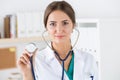 Portrait of beautiful female doctor holding stethoscope head