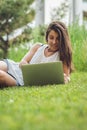 Portrait of beautiful female student preparing for classes in the park in summer Royalty Free Stock Photo