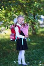 Portrait of a beautiful first-grader with a bouquet of flowers and a school bag. day of knowledge.