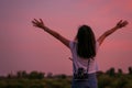 Portrait of beautiful freedom asian woman with holding medium format film camera with colorful sunset sky background