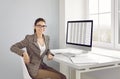 Portrait of beautiful friendly female accountant at her workplace in company office. Royalty Free Stock Photo