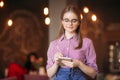 Portrait of a beautiful friendly waitress in glasses with notepapers and pen ready to take your order Royalty Free Stock Photo