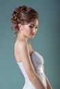 Portrait of a beautiful gentle and elegant girl women bride in a white dress with a beautiful hairstyle and makeup