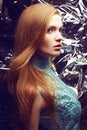 Portrait of beautiful ginger (red-haired) girl in blue dress Royalty Free Stock Photo