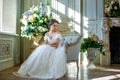 Portrait of a beautiful girl in a ball gown in the interior. Concept of tenderness and pure beauty in sweet princess look. Beautif Royalty Free Stock Photo