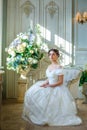 Portrait of a beautiful girl in a ball gown in the interior. Concept of tenderness and pure beauty in sweet princess look. Beautif Royalty Free Stock Photo