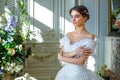 Portrait of a beautiful girl in a ball gown in the interior. Concept of tenderness and pure beauty in sweet princess look. Beautif Royalty Free Stock Photo