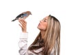 Portrait of beautiful girl with bird on the hand