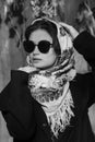 Portrait of a beautiful girl in black glasses and with an ethnic headscarf on her head Royalty Free Stock Photo