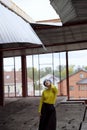 Portrait of beautiful girl with blue hair and red lips in a yellow sweater at the construction site Royalty Free Stock Photo