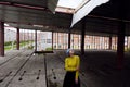 Portrait of beautiful girl with blue hair and red lips in a yellow sweater at the construction site Royalty Free Stock Photo