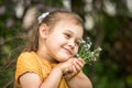 Portrait of a beautiful girl with a bouquet of forget-me-nots