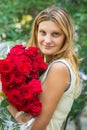 Portrait of a beautiful girl with a bouquet of roses in her hands Royalty Free Stock Photo