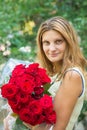 Portrait of a beautiful girl with a bouquet of roses in her hands Royalty Free Stock Photo