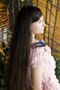 Portrait of beautiful girl with butterfly in a greenhouse Royalty Free Stock Photo