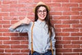 Portrait of beautiful girl in casual clothes and hat showing OK sign Royalty Free Stock Photo