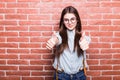 Portrait of beautiful girl in casual clothes showing OK sign Royalty Free Stock Photo