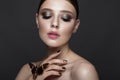 Portrait of beautiful girl with colorful make-up and cicada. Beauty face.