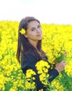 Portrait of a beautiful girl in the colza field in summer Royalty Free Stock Photo