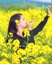 Portrait of a beautiful girl in the colza field in summer Royalty Free Stock Photo