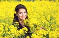 Portrait of a beautiful girl in the colza field in summer Royalty Free Stock Photo