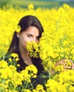 Portrait of a beautiful girl in the colza field in summer Royalty Free Stock Photo