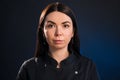 Portrait of a beautiful girl on a dark blue background, which with a serious face Royalty Free Stock Photo