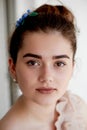 Portrait of beautiful girl with dark hair and light porcelain skin. Hair in a bun.Hair accessory handmade