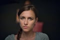 Portrait of a beautiful girl on a dark soft coloured background, which with a serious face Royalty Free Stock Photo