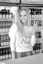 portrait of a beautiful girl in the department store on sale Beer `Bud`. Beer `Bud`, one of the most popular beers in the US Royalty Free Stock Photo