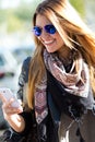 Portrait of beautiful girl drinking coffee and using her mobile Royalty Free Stock Photo