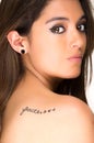 Portrait of beautiful girl with faith tatoo on her