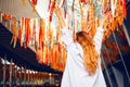 Portrait of a beautiful girl at the festival. A woman dances and smiles in a dress and glasses on a holiday against the background Royalty Free Stock Photo