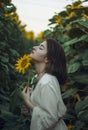 Portrait of a beautiful girl in a field of sunflowers. Warm summer shot of a girl in the field Royalty Free Stock Photo