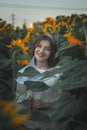 Portrait of a beautiful girl in a field of sunflowers. Warm summer shot of a girl in the field Royalty Free Stock Photo