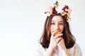 Portrait of beautiful girl with flower wreath eating apple Royalty Free Stock Photo