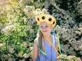 Portrait of beautiful girl with flowers of sunflowers on his head. Royalty Free Stock Photo