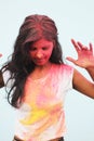 Portrait of a beautiful girl full of colored powder all over the body. Young girl plays with colors on the occasion of Holi. Royalty Free Stock Photo