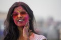 Portrait of a beautiful girl full of colored powder all over the body. Young girl plays with colors on the occasion of Holi.