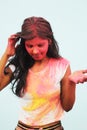 Portrait of a beautiful girl full of colored powder all over the body. Young girl plays with colors on the occasion of Holi. Royalty Free Stock Photo